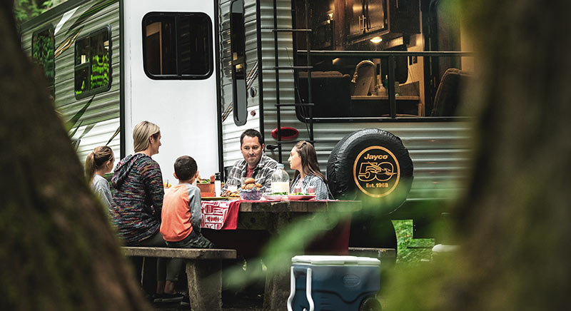 Photo of family at a campground with Jayco Jay Flight travel trailer.