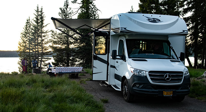 Photo of Jayco Melbourne class C motorhome parked at a lakeside campground.