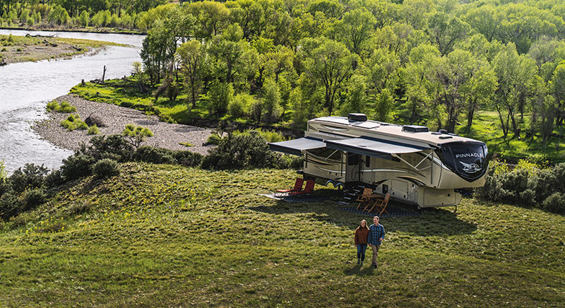 Photo of couple walking near Jayco Pinnacle fifth wheel.