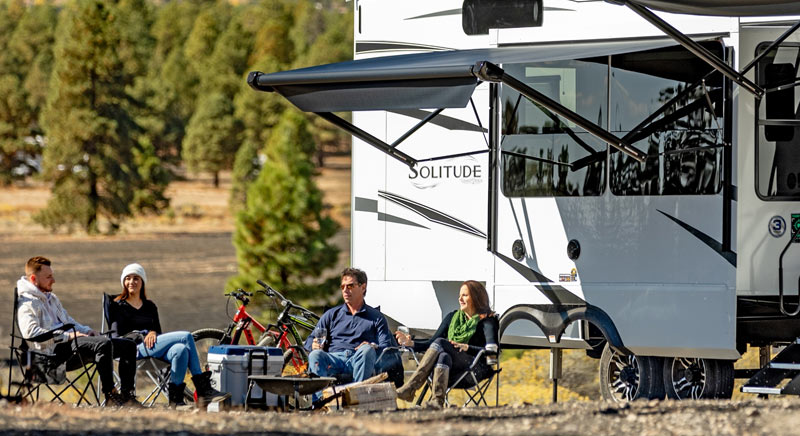 Photo of a Grand Design Solitude fifth wheel with a family.