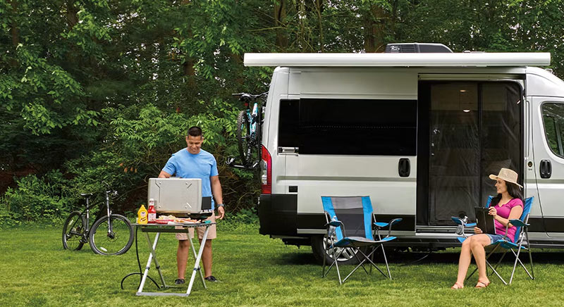 Photo of couple with their Jacyo Swift class B campervan.