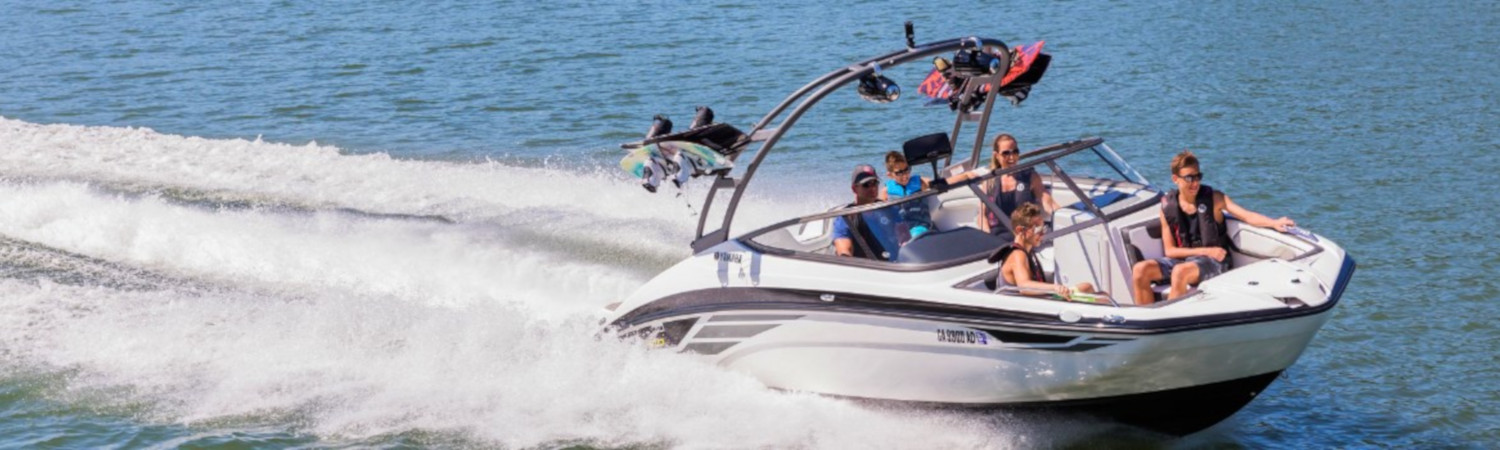 People on a wake boarding boat